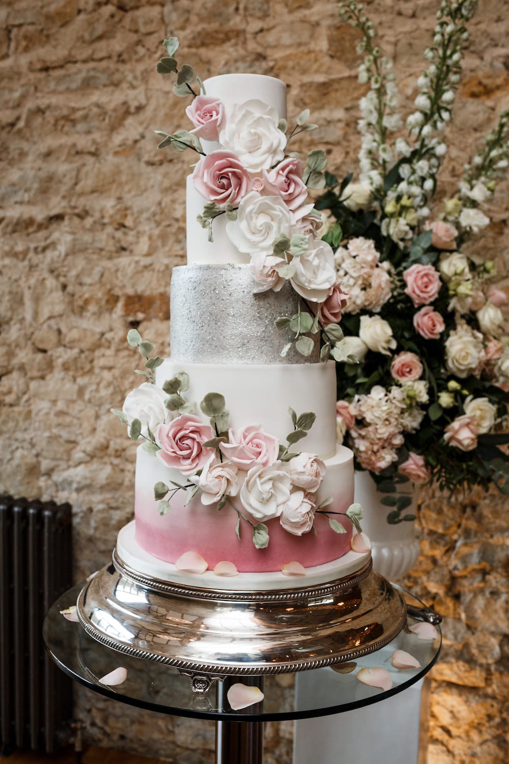 luxury tiered silver wedding cake with pink rose detailing
