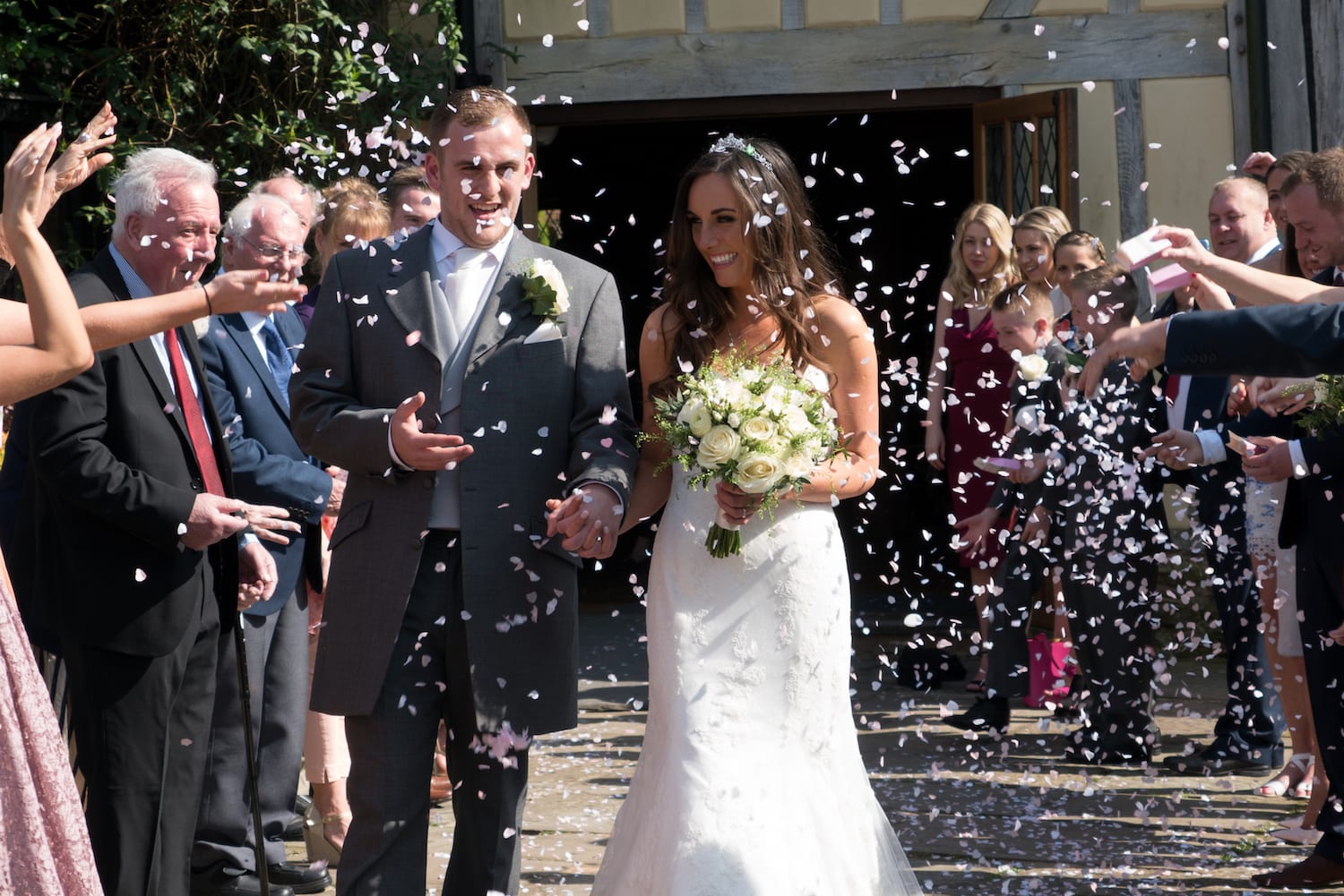Cain Manor Bride and Groom confetti shot with wedding party