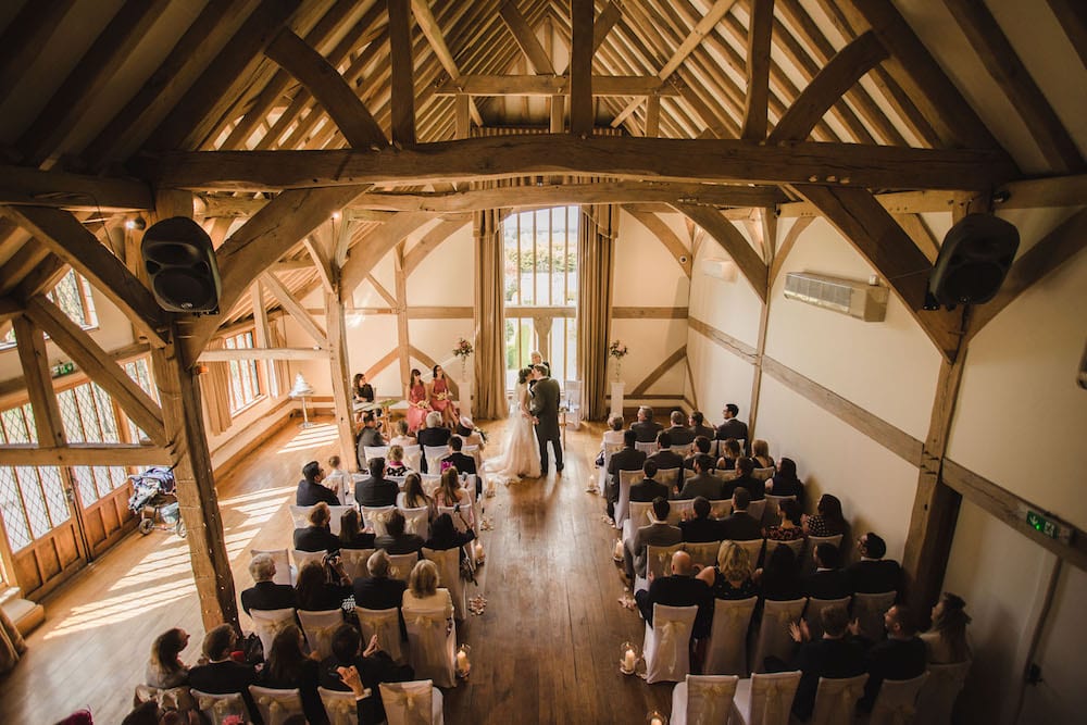 seated guests ceremony rustic barn wedding Cain Manor
