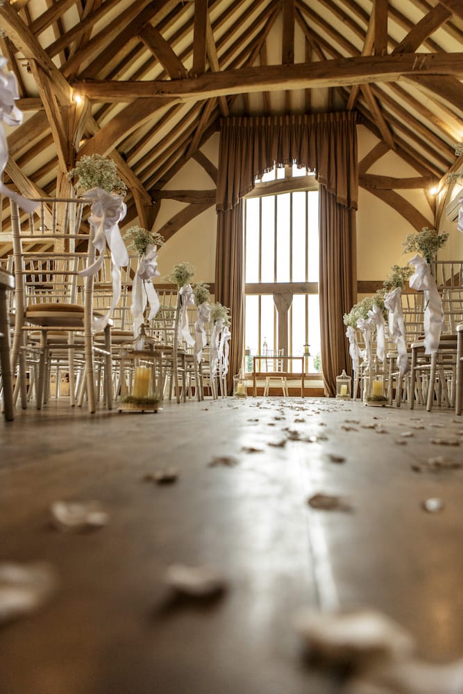 rustic barn indoor ceremony with gypsophlia chair decoration