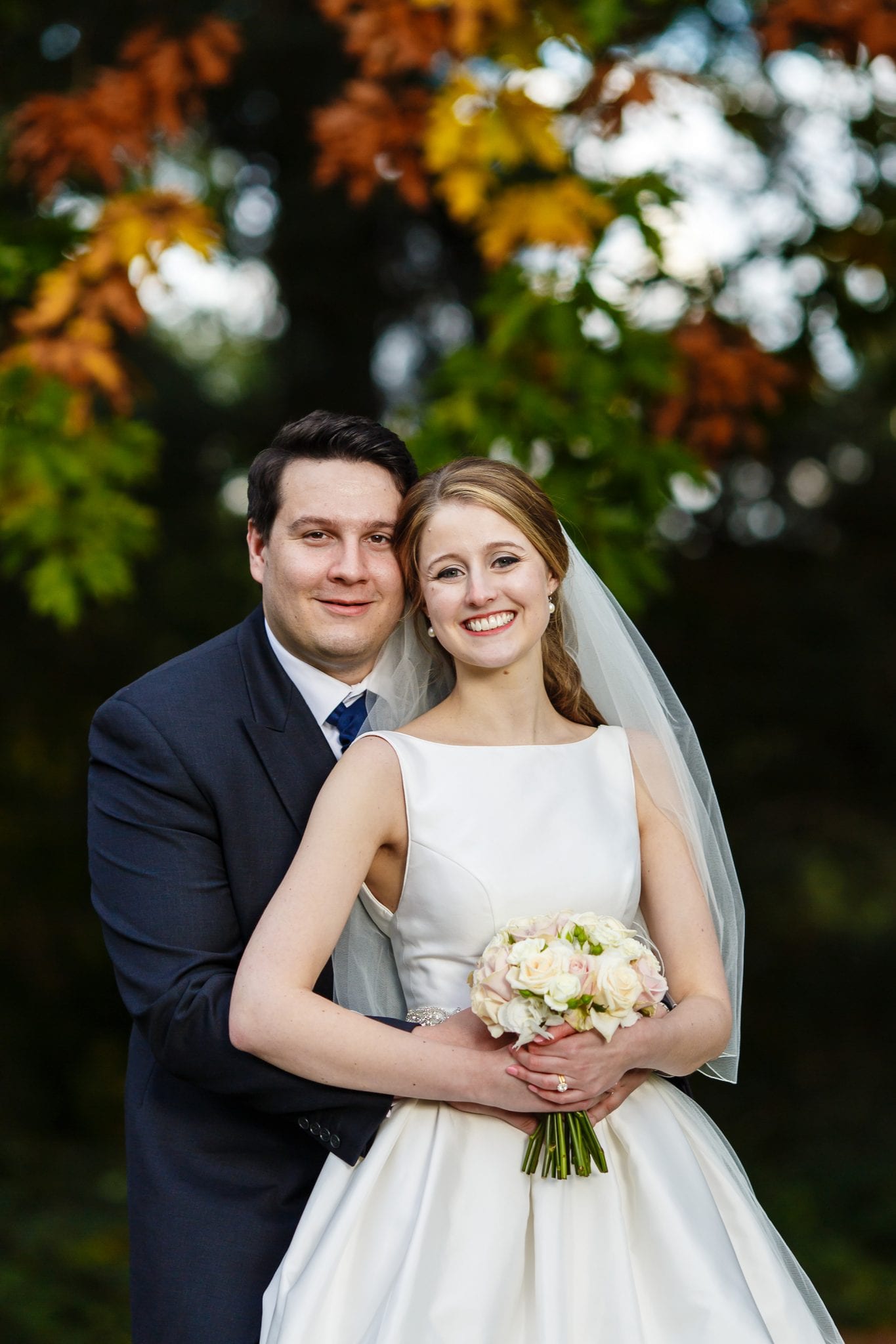 just married couple shot with cream roses bridal bouquet