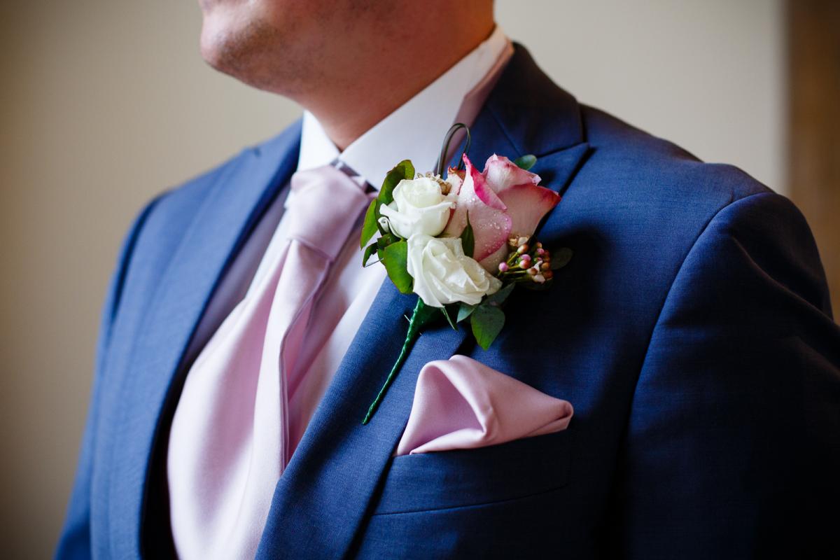 blue shot with pink tie and button hole