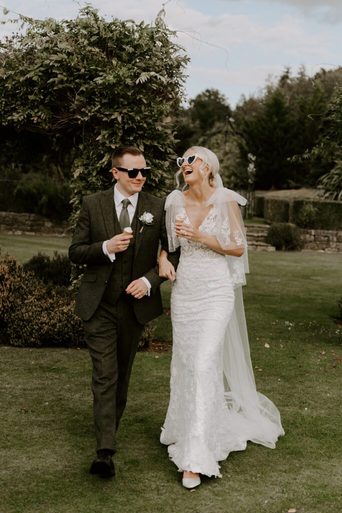 Couple with ice cream cones during an autumn wedding reception