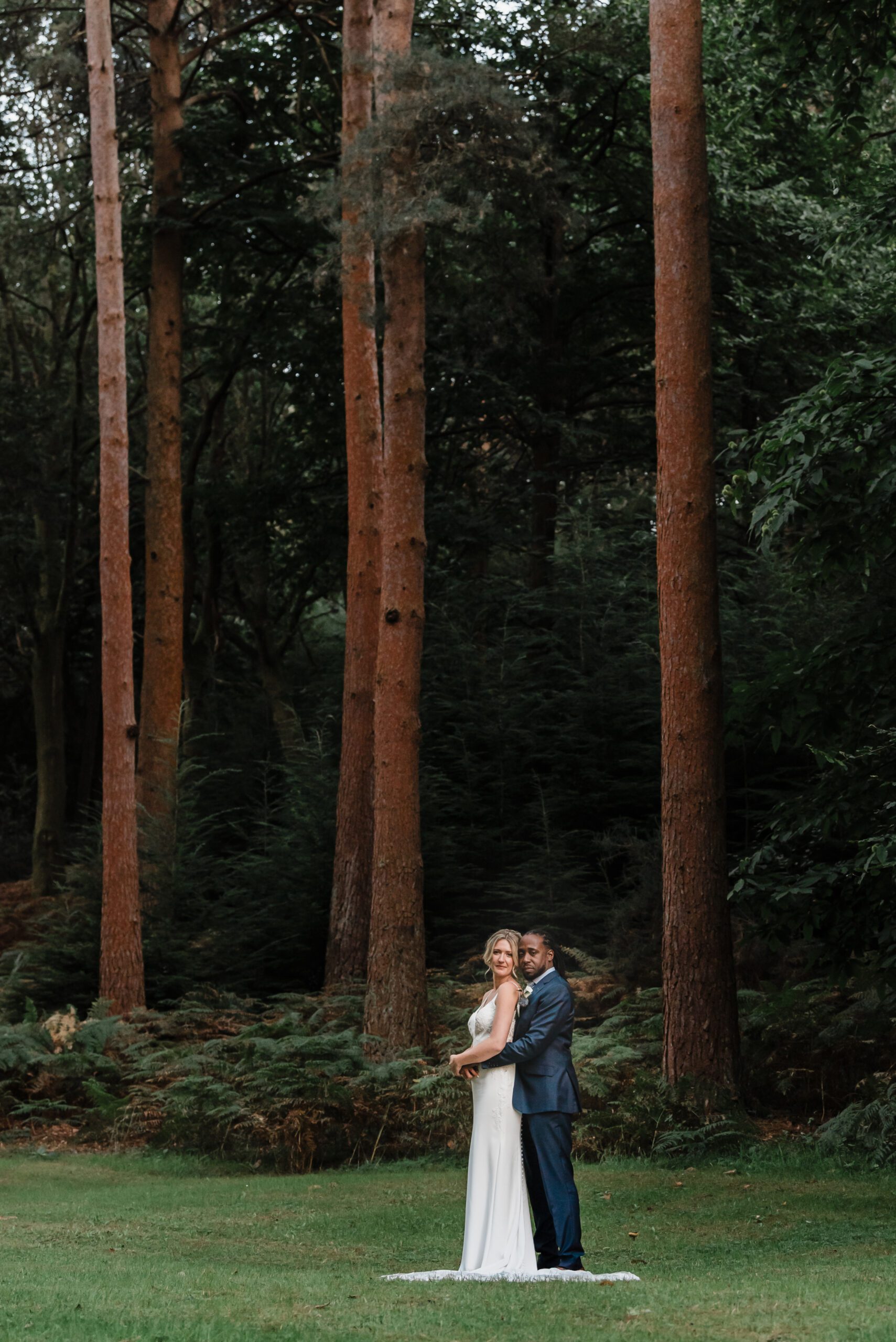 Bride and groom on a woodland driveway